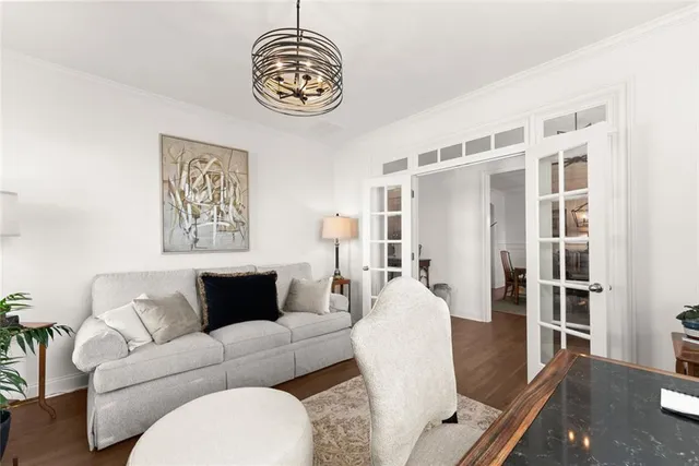 a large white kitchen with lots of counter top space a sink appliances and wooden floor