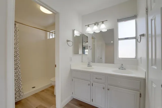 a bathroom with a double vanity sink and a mirror