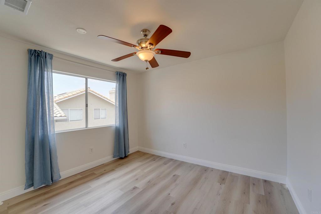 1354 Palomar Place Vista, CA 92084 - Photo 28 of 37 an empty room with windows and fan
