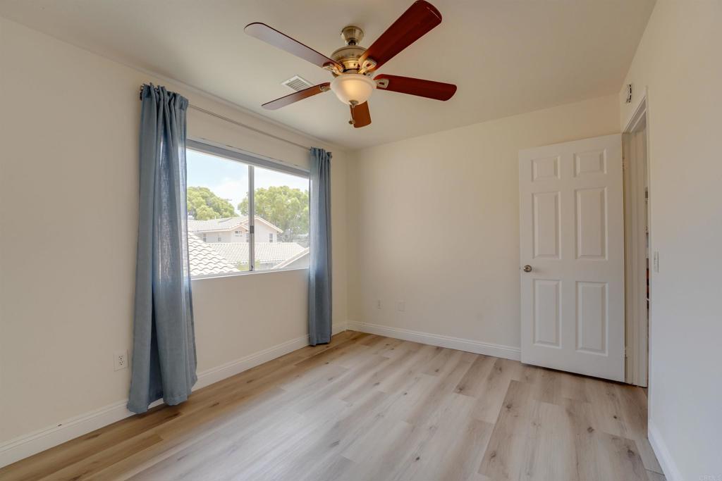 1354 Palomar Place Vista, CA 92084 - Photo 30 of 37 an empty room with wooden floor fan and windows