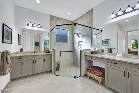 a spacious bathroom with a double vanity sink mirror and double