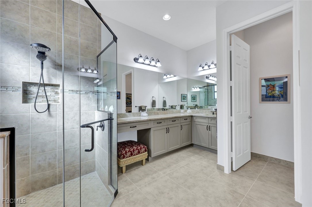 11725 Stonecreek Circle Fort Myers, FL 33913 - Photo 18 of 40 a bathroom with a double vanity sink mirror and shower