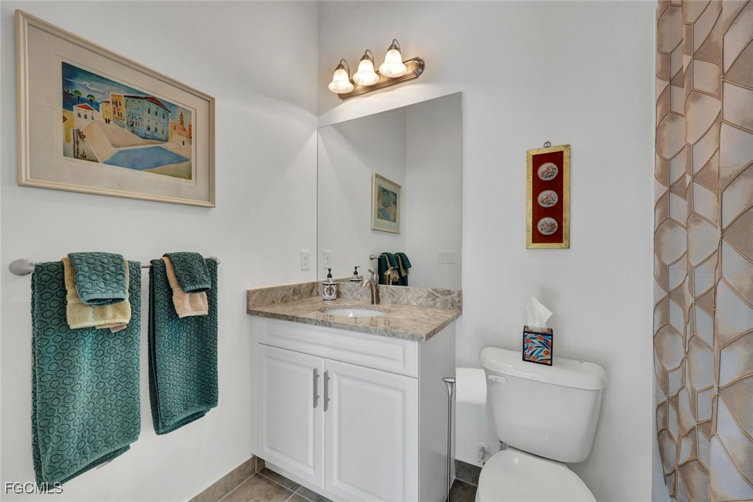 11725 Stonecreek Circle Fort Myers, FL 33913 - Photo 20 of 40 a bathroom with a toilet sink and mirror