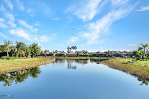 a view of a lake with houses in the back