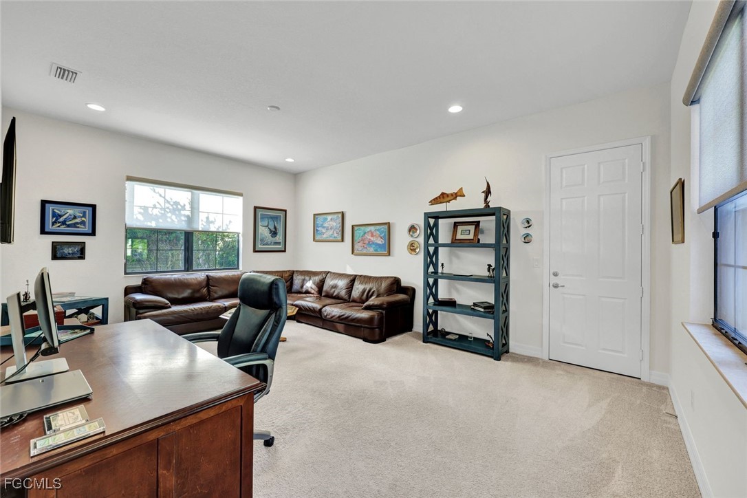 11725 Stonecreek Circle Fort Myers, FL 33913 - Photo 24 of 40 a living room with furniture and a flat screen tv