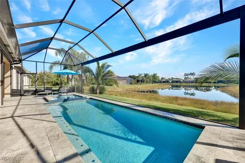 a view of swimming pool with a lounge chairs