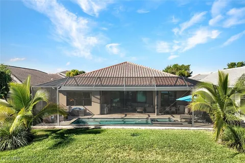 a front view of a house with swimming pool having outdoor seating