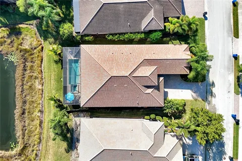 an aerial view of a house with a yard and potted plants