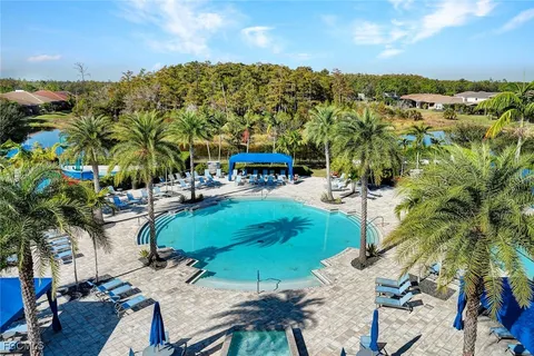 a view of a swimming pool and lounge chairs