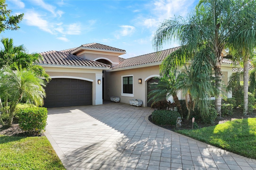 11725 Stonecreek Circle Fort Myers, FL 33913 - Photo 4 of 40 a front view of a house with a garden and plants