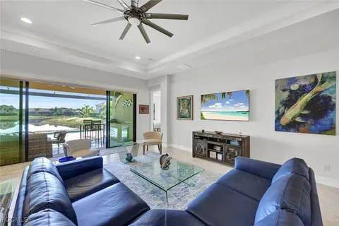 a living room with furniture and a flat screen tv with wooden floor