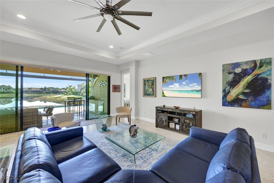 11725 Stonecreek Circle Fort Myers, FL 33913 - Photo 6 of 40 a living room with furniture and a flat screen tv with wooden floor