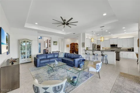 a living room with furniture and view of kitchen
