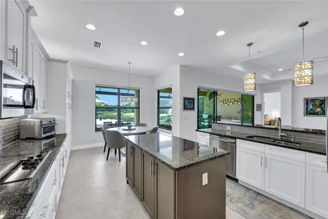 a kitchen with counter space sink stove and chairs