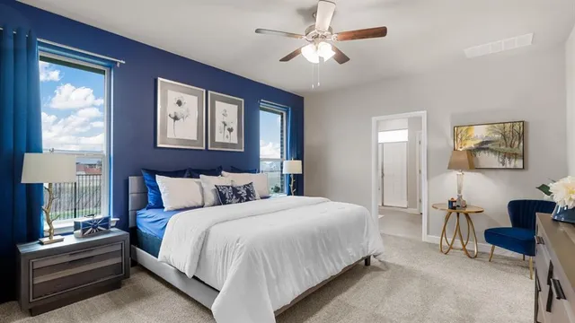 a bedroom with a bed and a painting on the wall