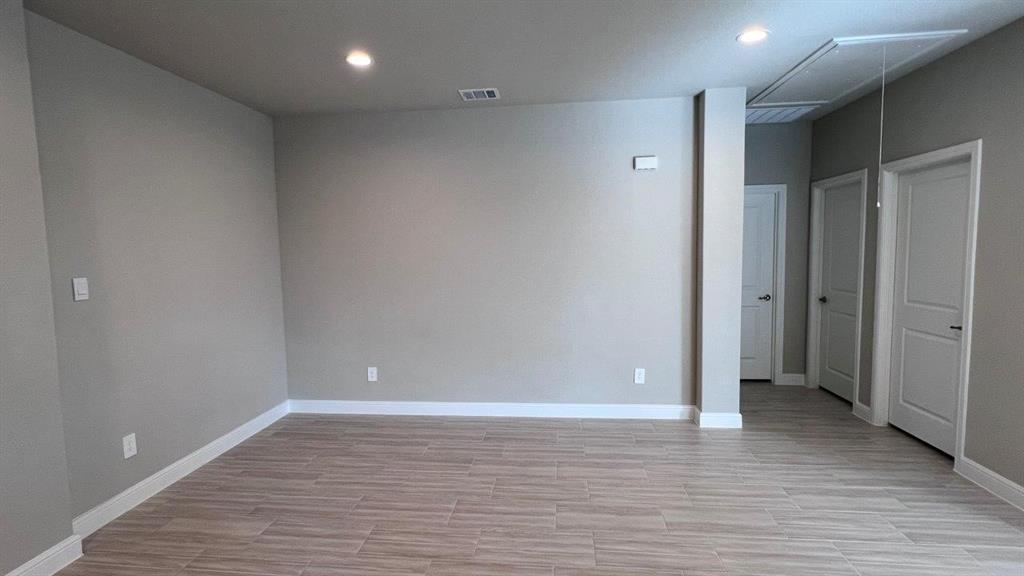 125 Medina Lane Rhome, TX 76078 - Photo 3 of 21 an empty room with wooden floor and windows