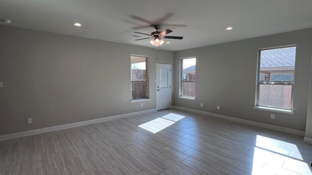 125 Medina Lane Rhome, TX 76078 - Photo 4 of 21 a view of a livingroom with a ceiling fan and window