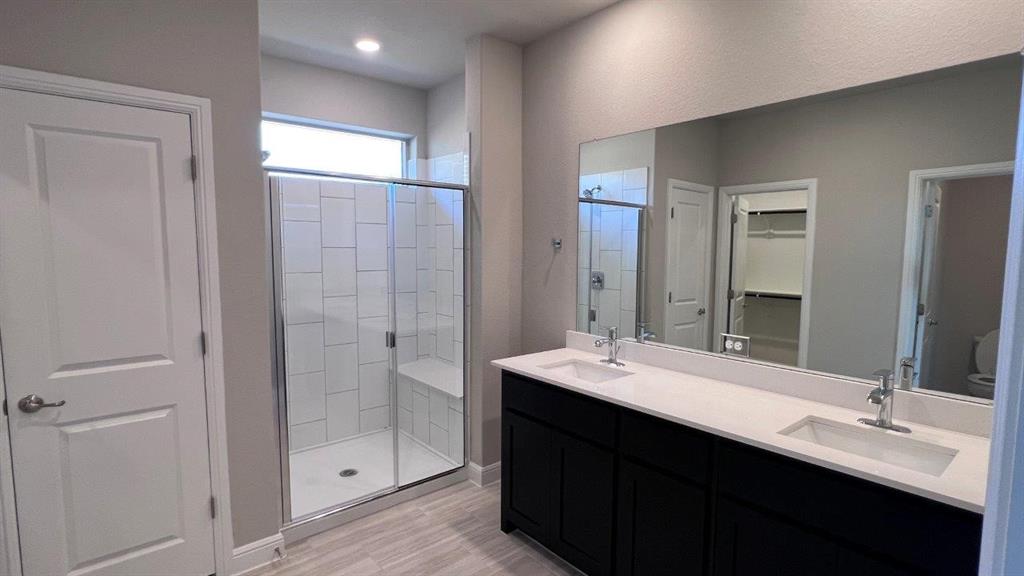 125 Medina Lane Rhome, TX 76078 - Photo 6 of 21 a bathroom with a double vanity sink mirror and shower