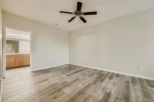a view of an empty room and window with wooden floor