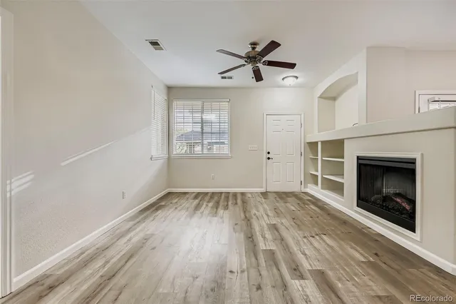 wooden floor in an empty room with a window