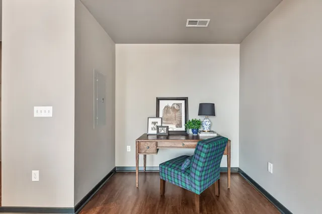 a dining room with furniture and wooden floor