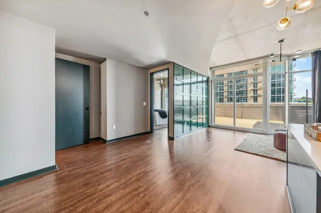 a view of a room with wooden floor and windows