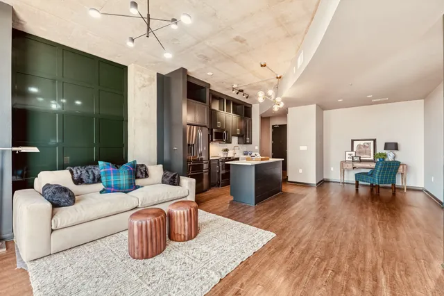 a living room with furniture and kitchen view