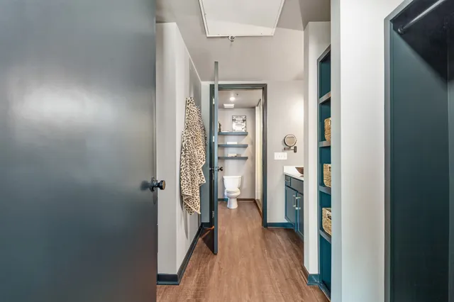 a view of a hallway with wooden floor and staircase