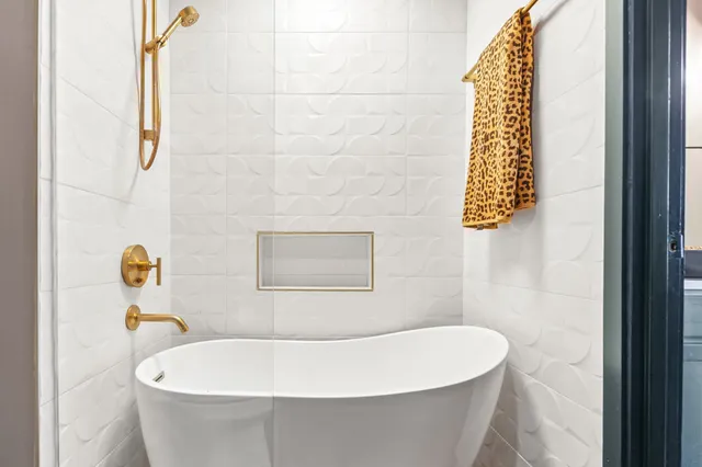 a white bath tub sitting next to a white sink