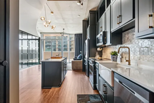 a kitchen with stainless steel appliances granite countertop a stove and a sink
