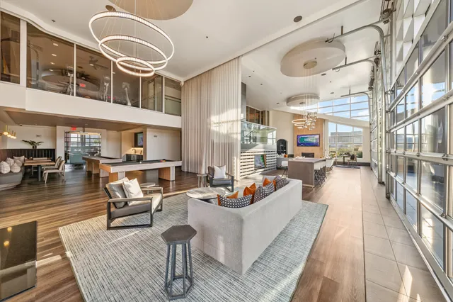 a living room with fireplace furniture and a large window