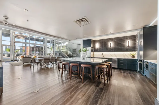 a view of a room with wooden floor and large windows