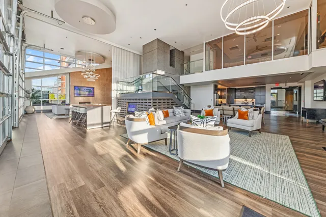 a view of a patio with dining table and chairs with a barbeque