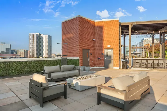 a kitchen with a sink a counter top space and stainless steel appliances