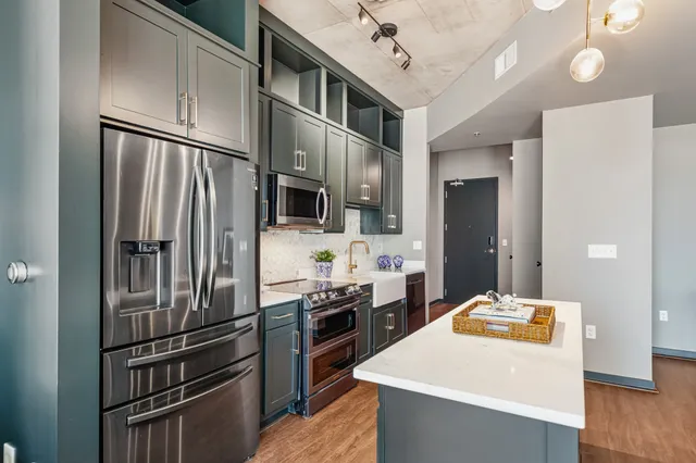 a kitchen with stainless steel appliances a refrigerator and a stove