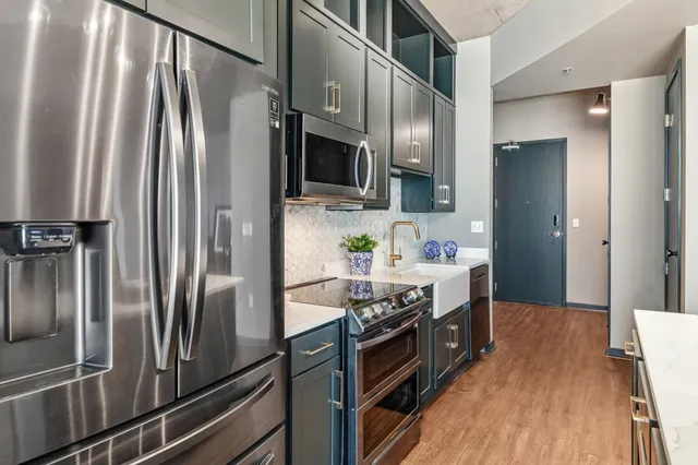 a kitchen with stainless steel appliances a refrigerator and a stove