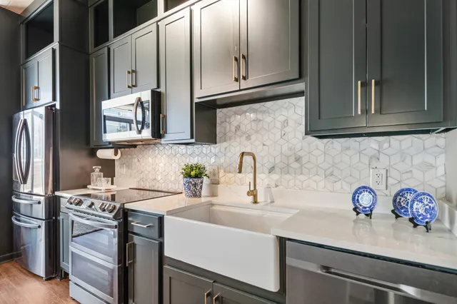 a kitchen with stainless steel appliances granite countertop a sink stove and refrigerator