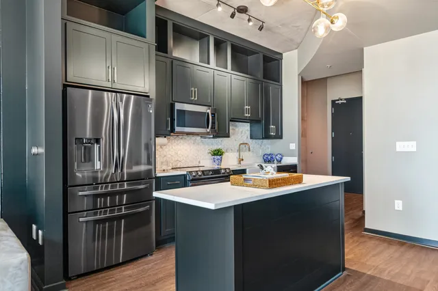 a kitchen with stainless steel appliances a refrigerator stove and microwave