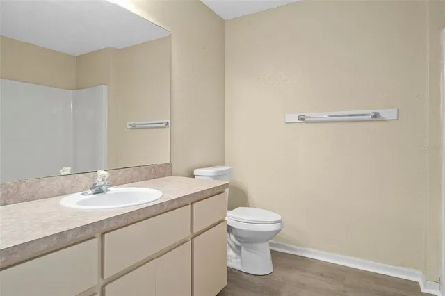 a bathroom with a sink toilet and vanity