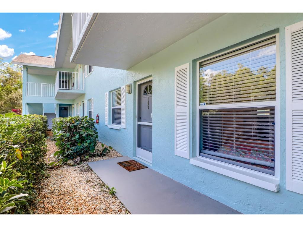 5739 Whitaker Road, Unit 103 Naples, FL 34112 - Photo 2 of 18 a view of outdoor space and deck