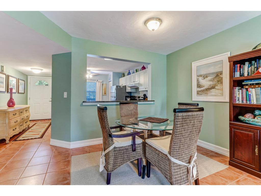 5739 Whitaker Road, Unit 103 Naples, FL 34112 - Photo 12 of 18 a dining room with furniture and a kitchen view