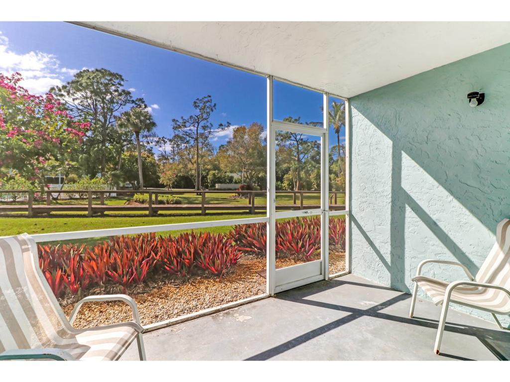 5739 Whitaker Road, Unit 103 Naples, FL 34112 - Photo 17 of 18 a view of swimming pool with outdoor seating and city view