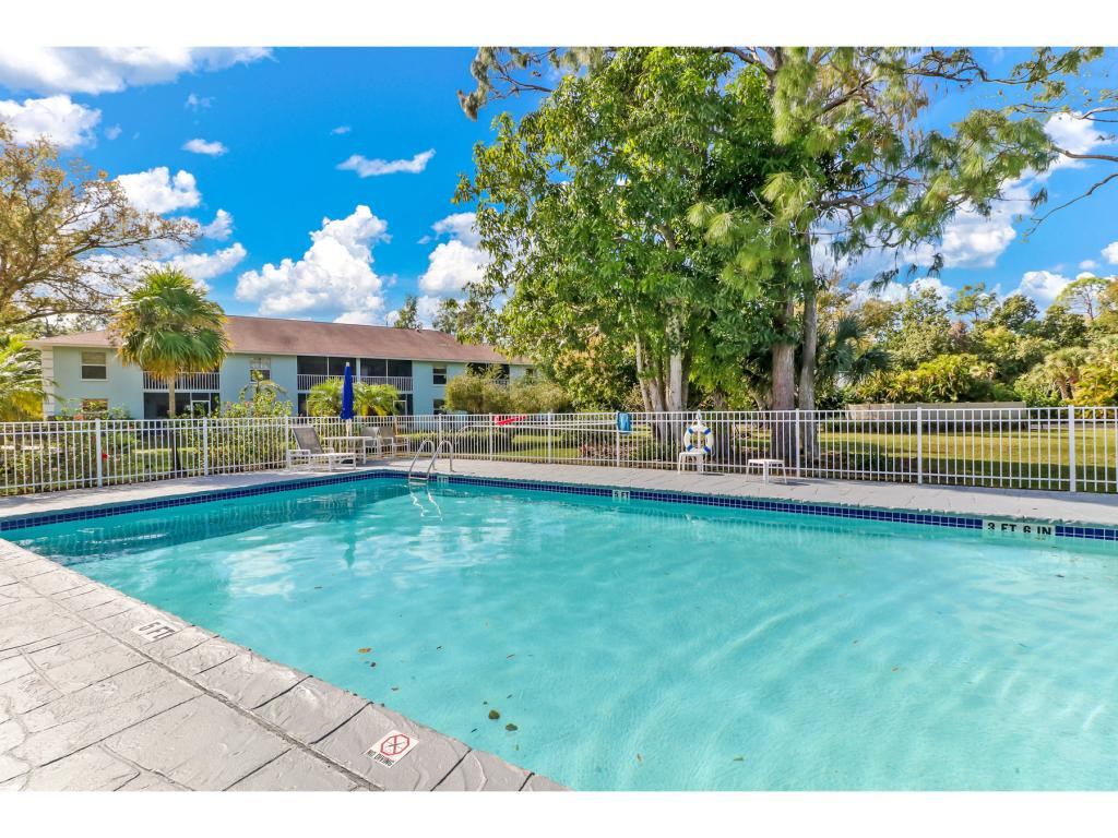 5739 Whitaker Road, Unit 103 Naples, FL 34112 - Photo 18 of 18 a view of a house with a swimming pool