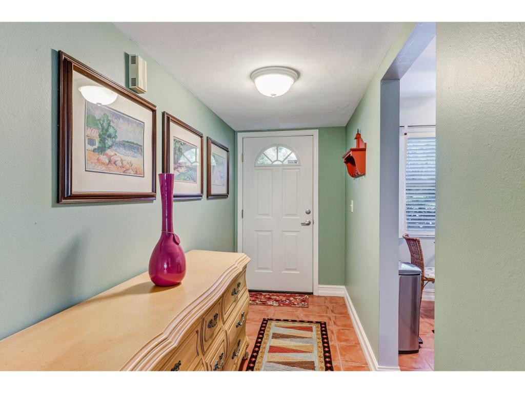 5739 Whitaker Road, Unit 103 Naples, FL 34112 - Photo 3 of 18 a very nice looking room with a red couch