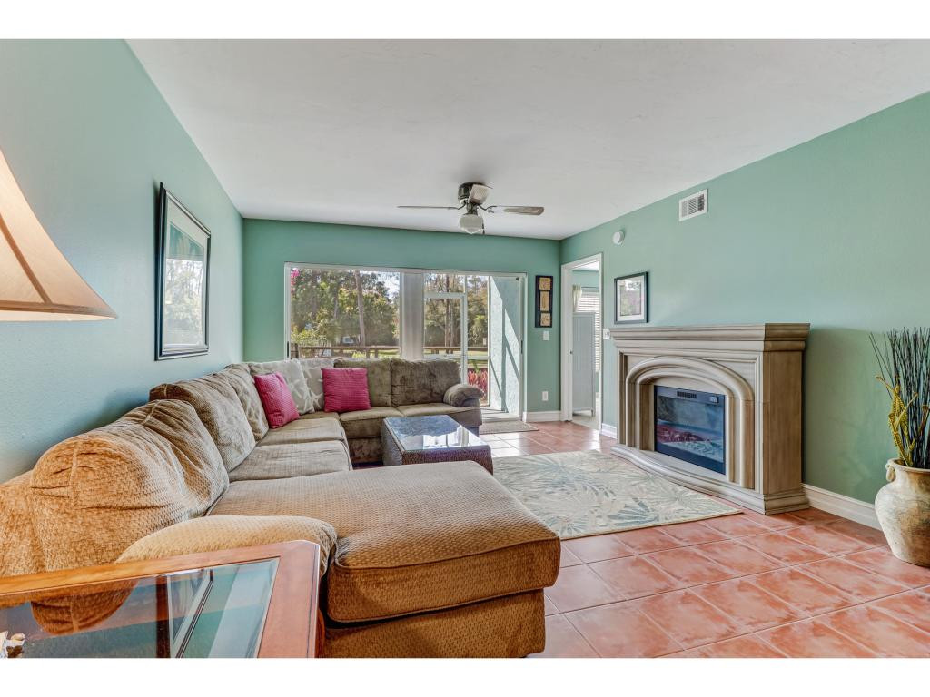 5739 Whitaker Road, Unit 103 Naples, FL 34112 - Photo 5 of 18 a living room with furniture and a fireplace