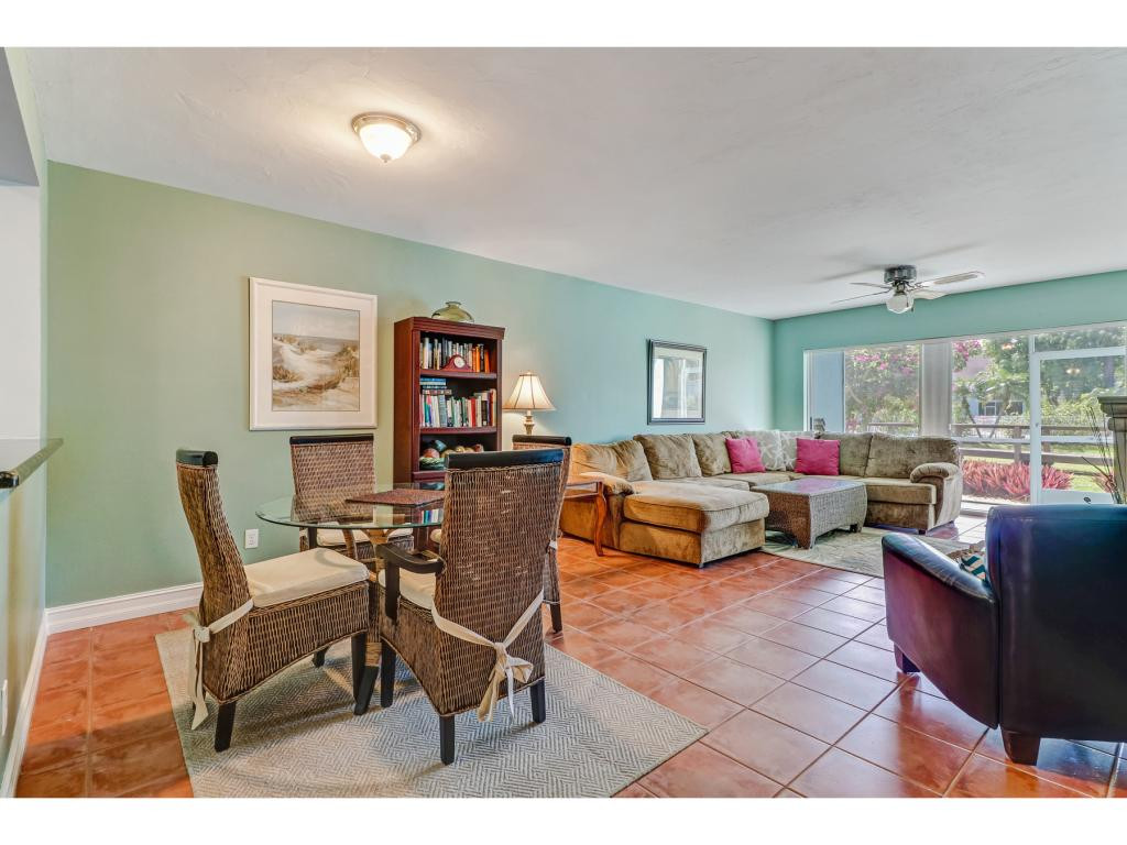 5739 Whitaker Road, Unit 103 Naples, FL 34112 - Photo 6 of 18 a living room with furniture and a large window