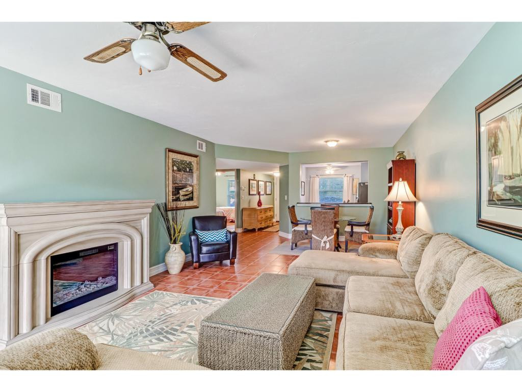 5739 Whitaker Road, Unit 103 Naples, FL 34112 - Photo 7 of 18 a living room with furniture and a fireplace