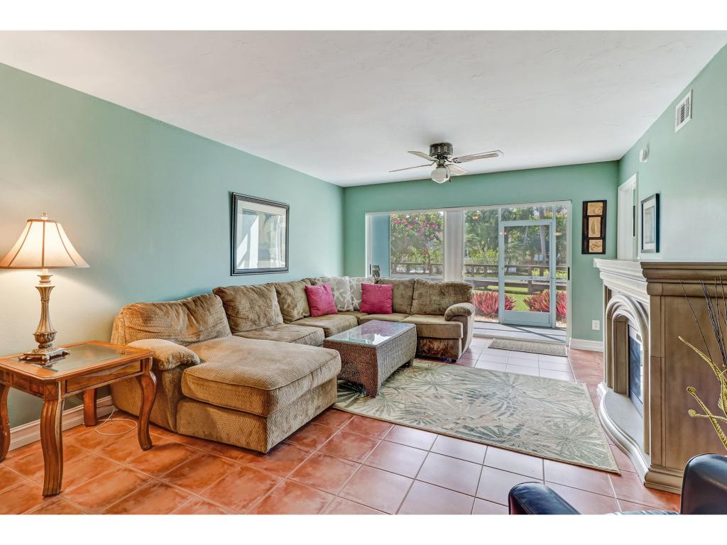 5739 Whitaker Road, Unit 103 Naples, FL 34112 - Photo 8 of 18 a living room with furniture and a fireplace