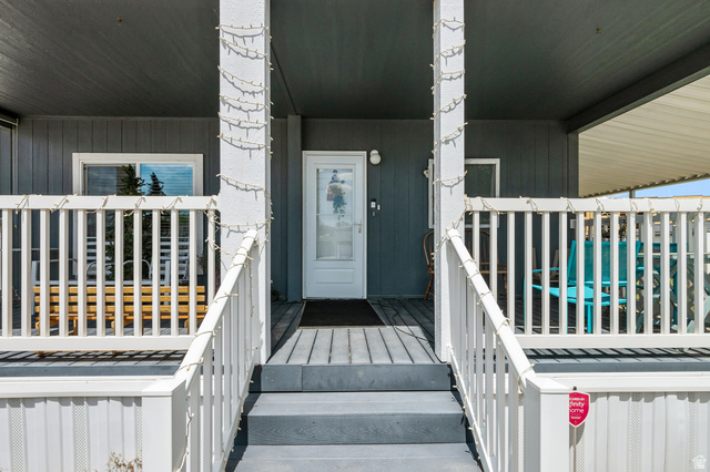 150 West 7500th South, Unit 13 Midvale, UT 84047 - Photo 24 of 32 Covered front porch with white railings and gray steps