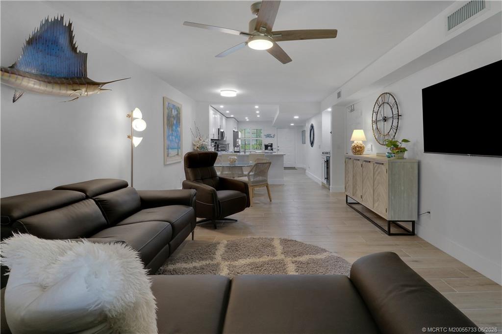 1001 Keystone Drive, Unit A Jupiter, FL 33458 - Photo 12 of 30 a living room with furniture and a flat screen tv